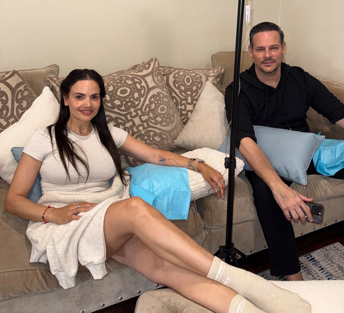 Couple getting IV drips on their couch